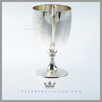 The English silver plated vase shaped mug stands on a pedestal foot with a scroll handle with beading. Feinberg Silver