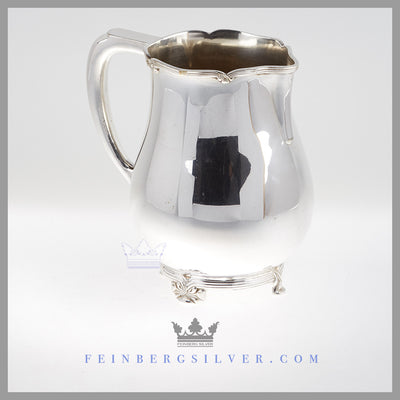 Feinberg Silver - The pear shaped silver plated pitcher is on a cast thread and ribbon rim and foot.