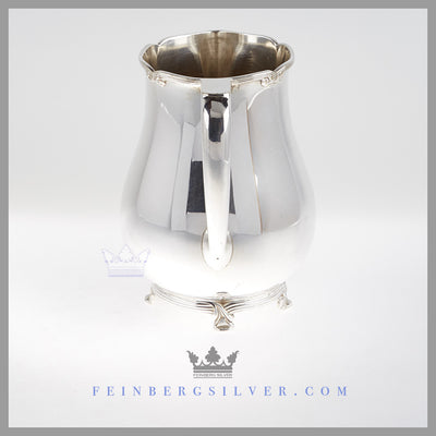 Feinberg Silver - The pear shaped silver plated pitcher is on a cast thread and ribbon rim and foot.