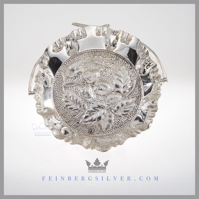 Feinberg Silver - The round English silver plated basket has a swing handle with Scottish thistles on the top of the handle.