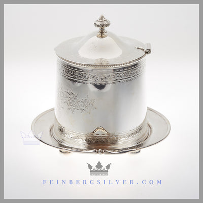The oval English silver plated biscuit box has 2 cast handles. Feinberg Silver