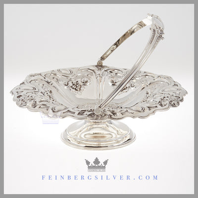 Feinberg Silver - The round English silver plated basket is reticulated with 6 sections of chased flowers and fruit and stands on a pedestal base.